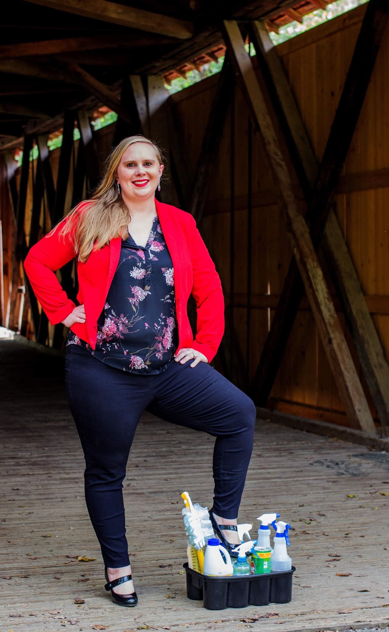 Photo of Liz Wiley with her foot propped on a bucket of cleaning supplies